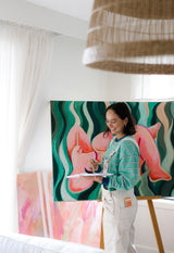 Woman painting indoors with Sunii Energy Gum nearby, showing creativity fueled by Sunii